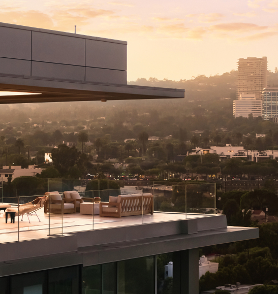 A large wraparound terrace is viewed from the side, revealing spectacular views of Los Angeles.